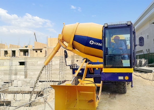 Self-loading concrete mixer