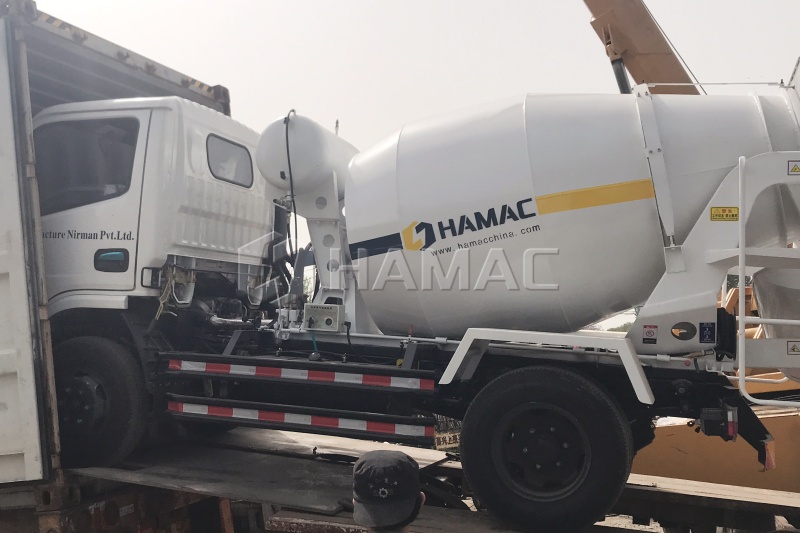 Concrete mixer truck being loaded into container for shipment to Nepal